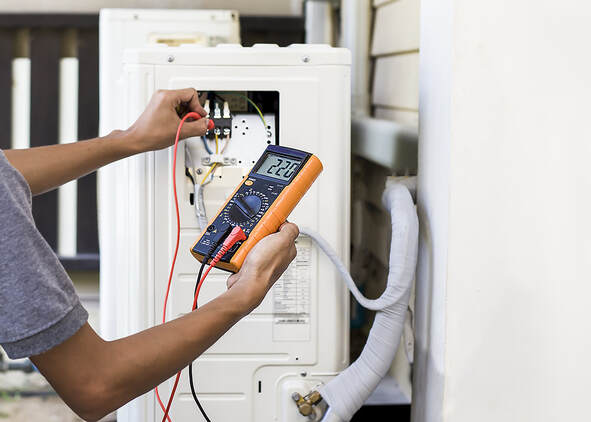 Using measuring equipment, an air repair mechanic checks an air conditioner in Greenwich, Connecticut.